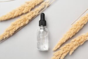 Cosmetic serum and dry pampas herbs. Hyaluronic acid oil, serum with collagen and peptides.