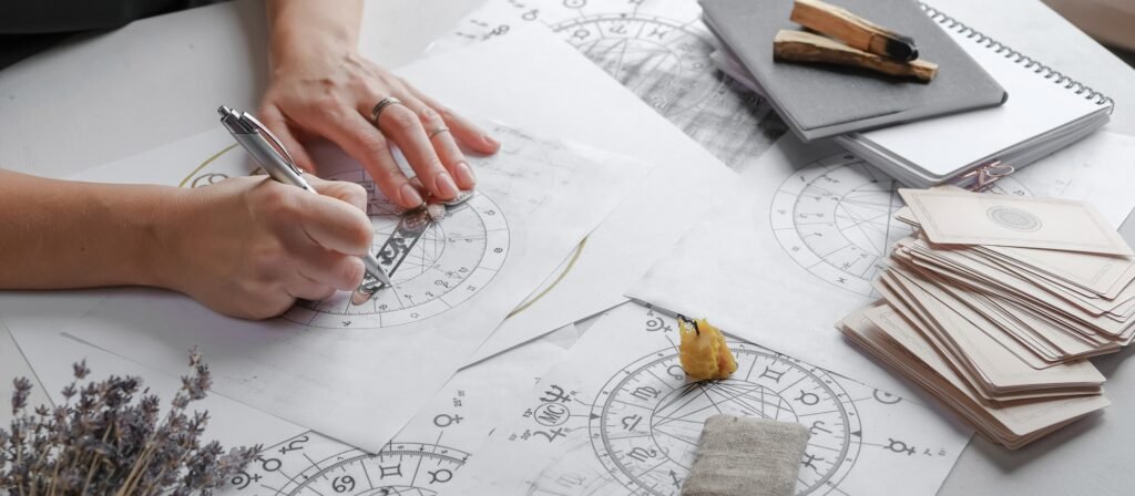 Astrology. Astrologer calculates natal chart and makes a forecast of fate Tarot cards