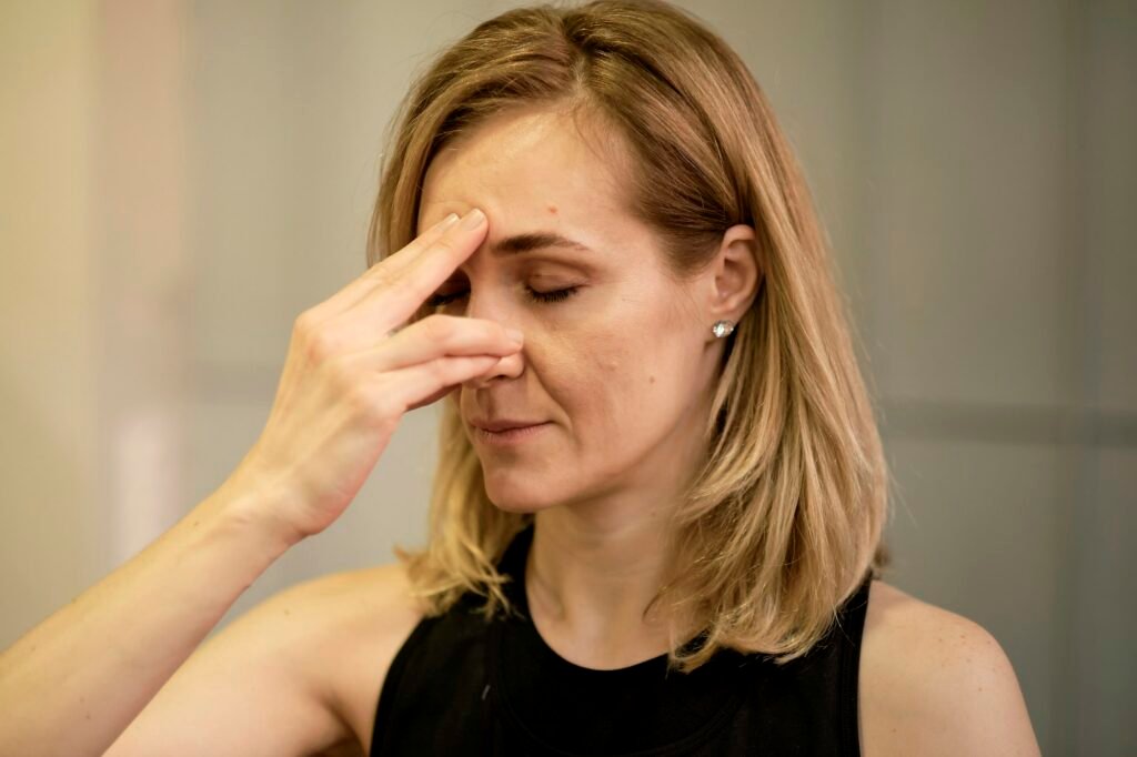 Breathing with a change of nostril. middle aged woman doing breathing exercises yoga