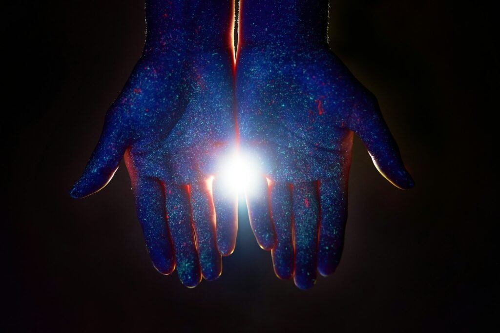 Light through the palms of your hands in ultraviolet, God and religion. Divine light through hand