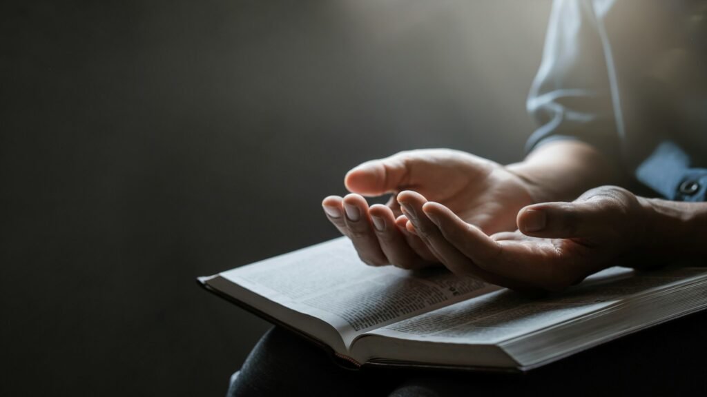 Put your hands together and open the bible. Concept of Hope, Faith