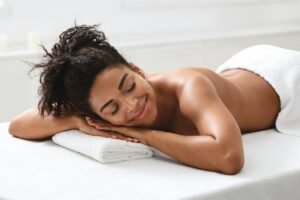 Relaxed african american woman resting after healing massage