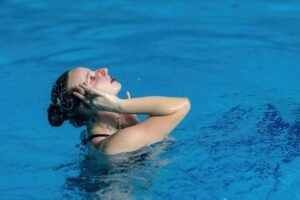 Solo synchronized swimming performance, blending grace and precision in aquatic artistry