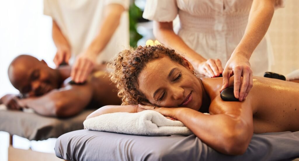 Spa, wellness and massage for couple and hot stone therapy, massage therapist hands for stress reli