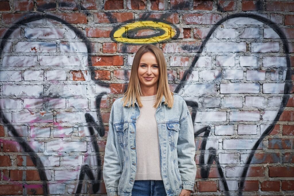 Young adult woman with angel wing on the wall