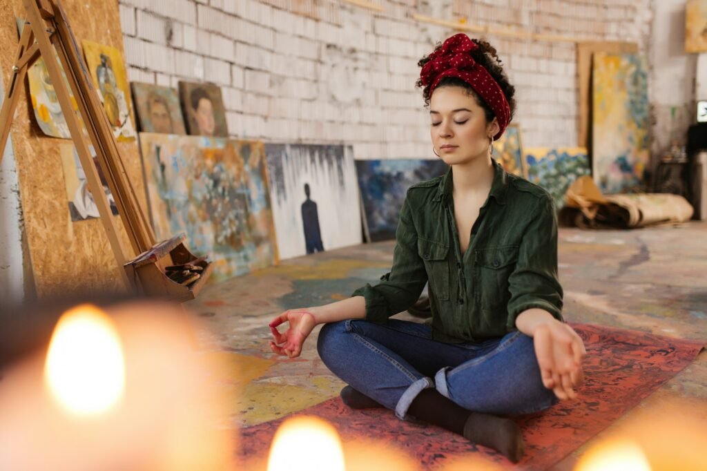 Young thoughtful woman with closing eyes sitting on yoga mat in