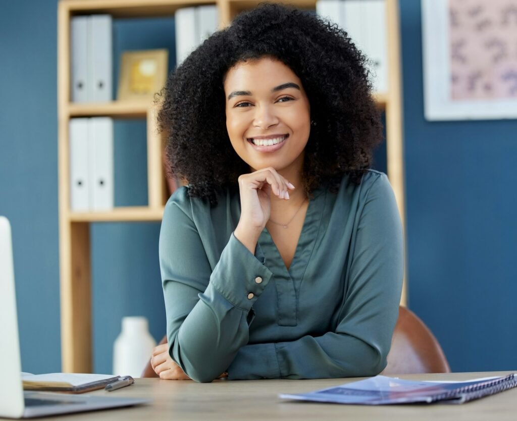 Business, woman and portrait of lawyer or legal advocate at her desk in the office ready for a case