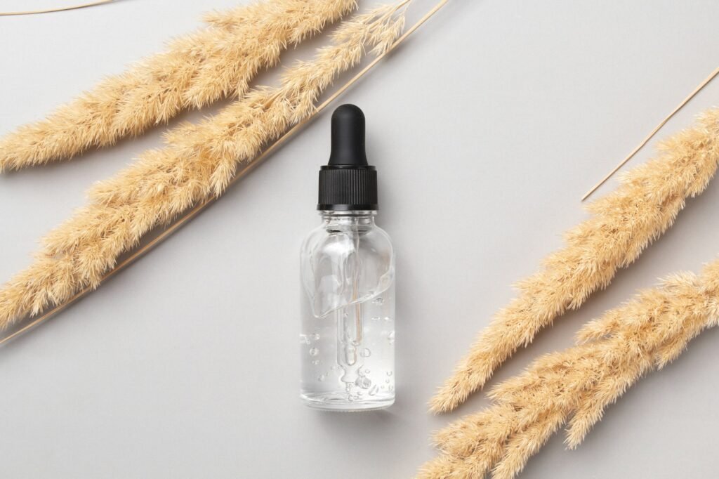 Cosmetic serum and dry pampas herbs. Hyaluronic acid oil, serum with collagen and peptides.