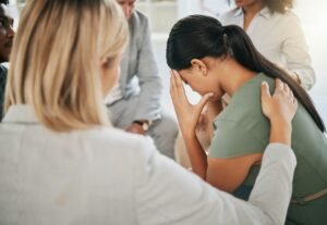 Grief, loss and woman at community support group for mental health, counseling or help. Solidarity,