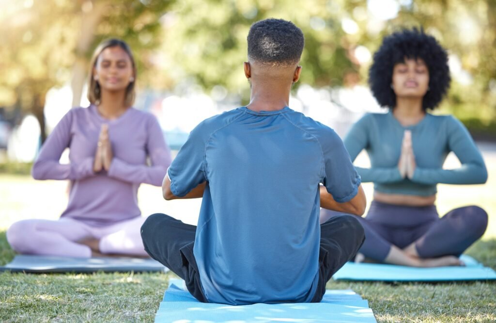 Mediation, coaching and yoga class with people in park for relax, mindfulness and spirituality. Zen