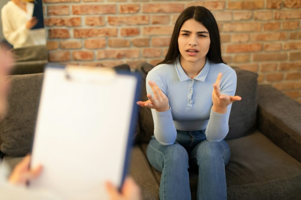 Mental health and psychological assistance concept. Teen indian lady having counseling session with