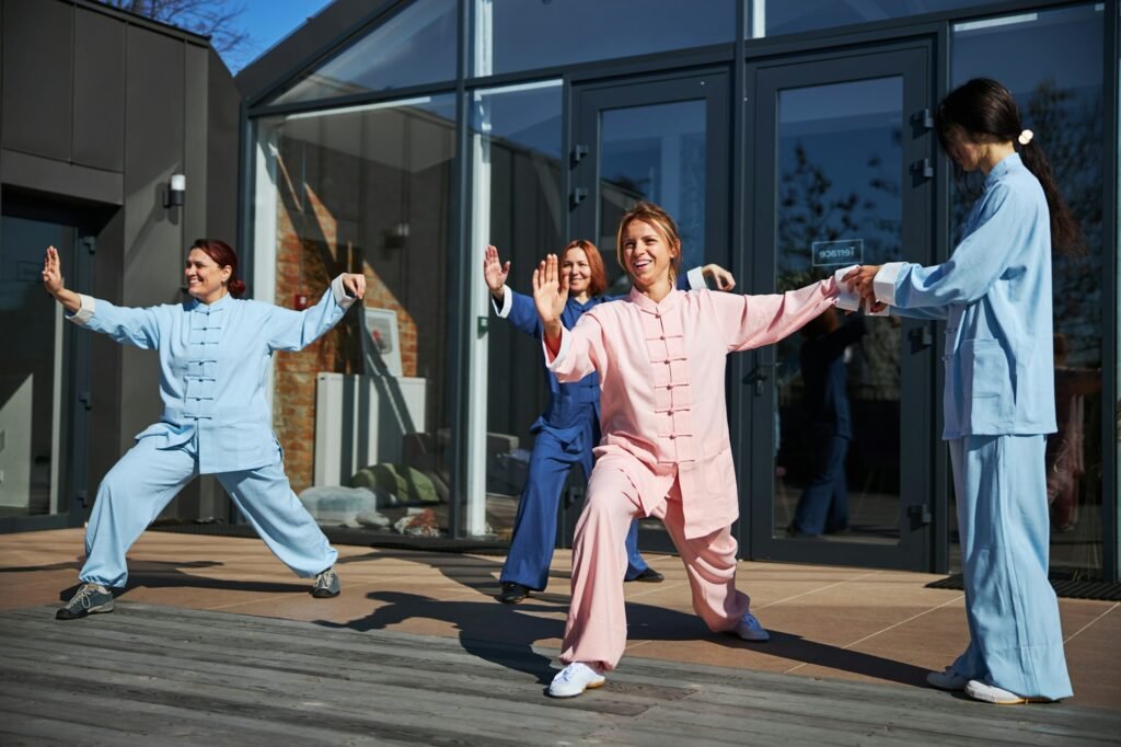 Mirthful young women practicing qigong on the terrace