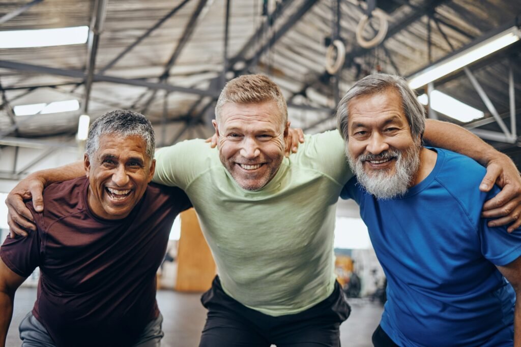 Portrait, hug or mature men in workout gym, training exercise or healthcare wellness in success cel