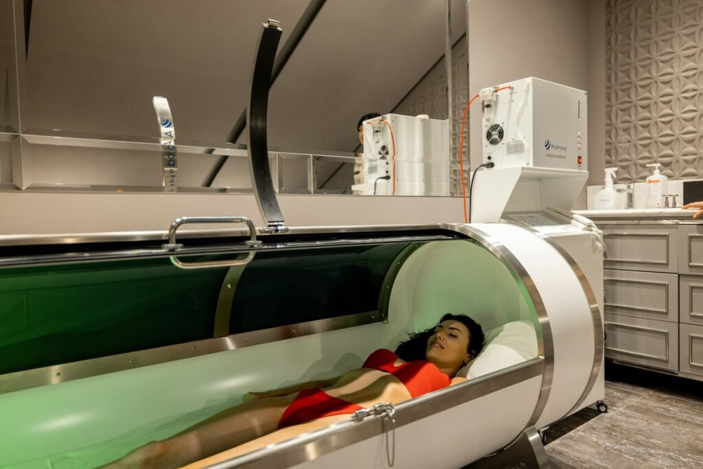 Woman lying in oxygen capsule