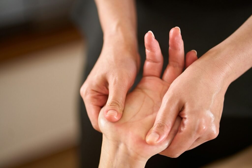 Woman receiving hand massage at beauty salon