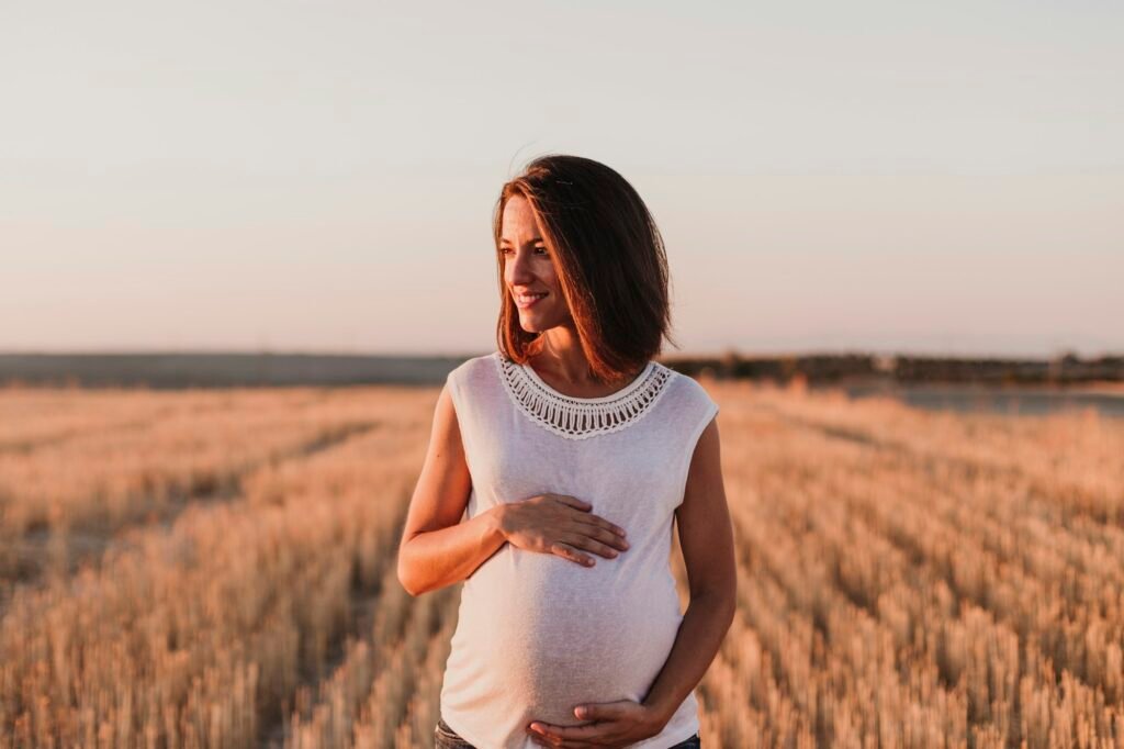 young beautiful pregnant woman touching her belly while expecting a baby