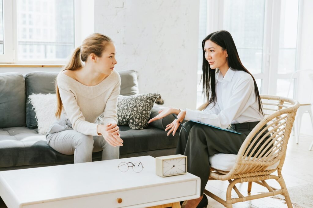 young woman in office at psychologist's appointment, female specialist psychotherapist conducts cons